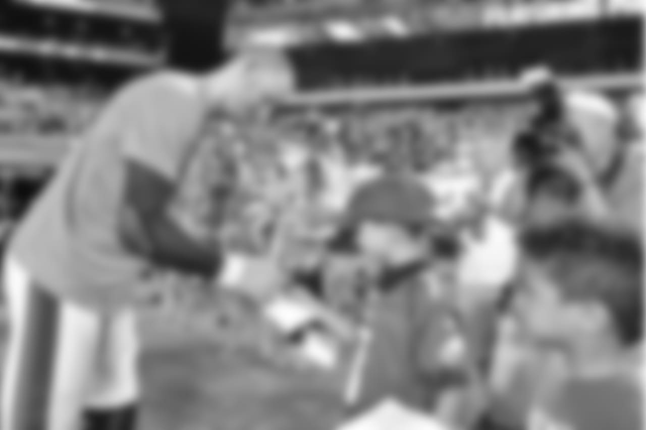 QB Carson Wentz signs an autograph for a young fan.