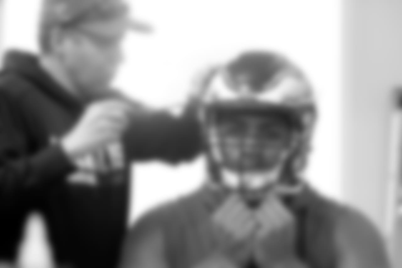 Mailata has his helmet adjusted.
