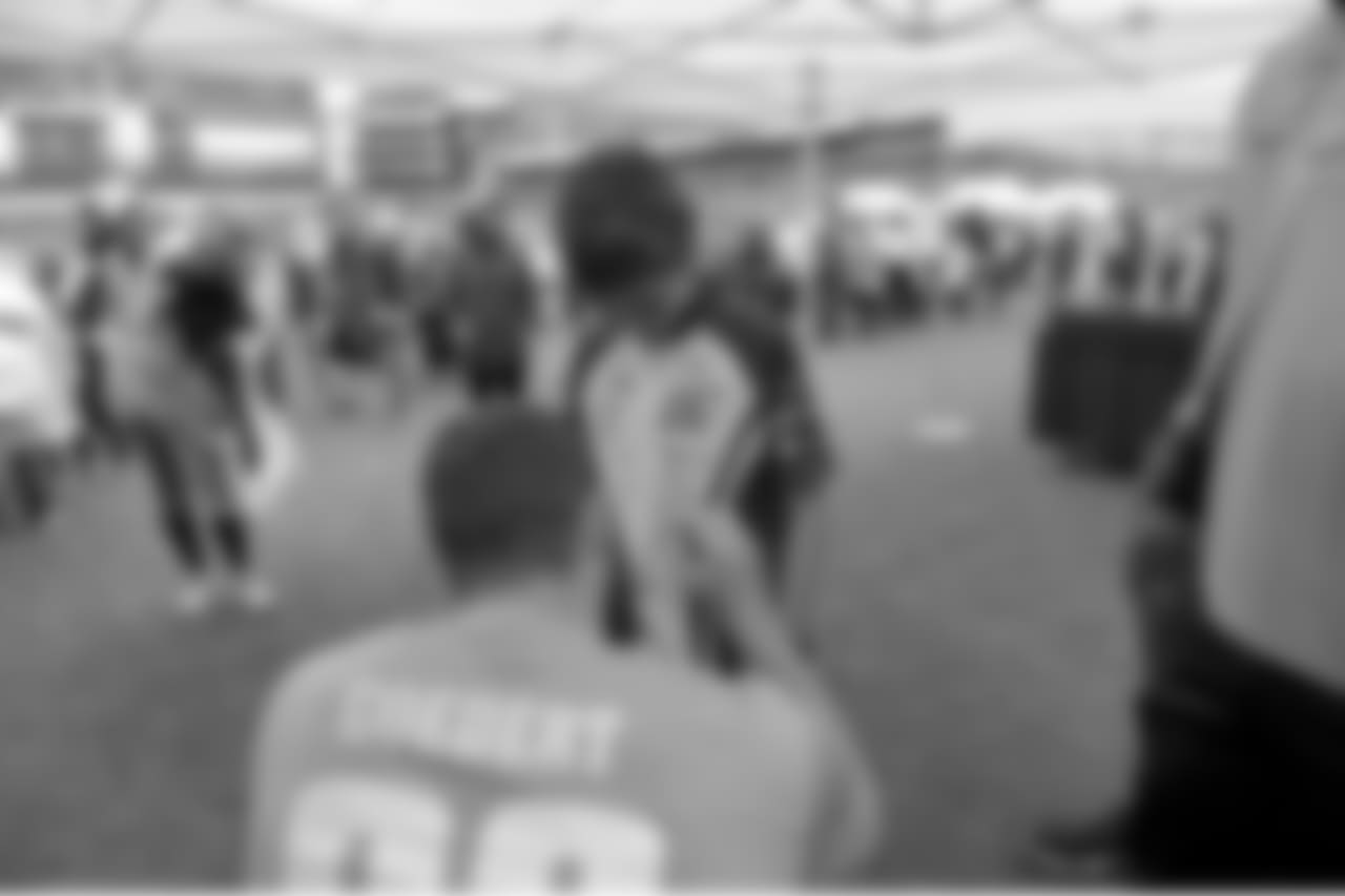 TE Dallas Goedert signs an autograph for a young fan.