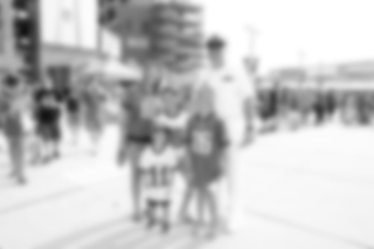 A family stops for a quick photo before heading in for practice.
