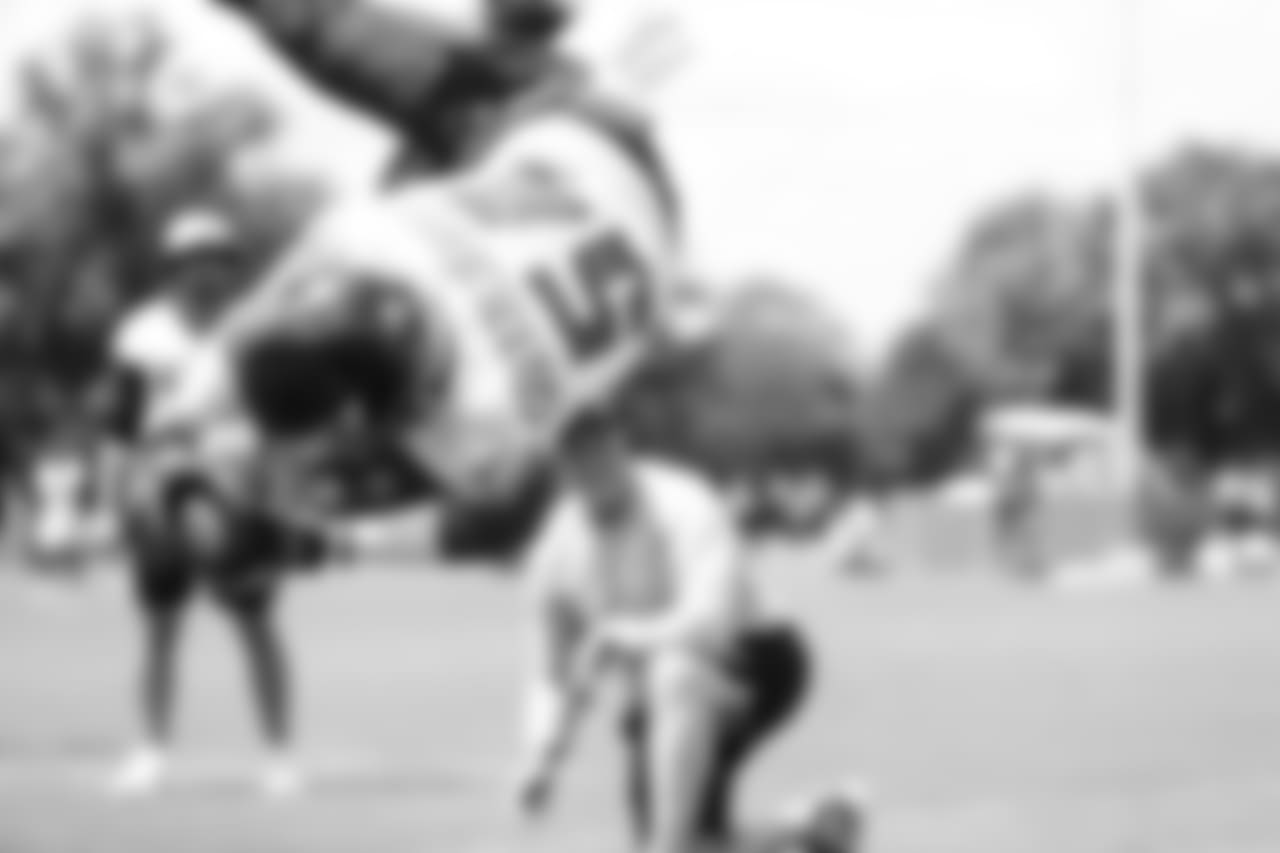 LB Kamu Grugier-Hill takes to the air to catch the ball.
