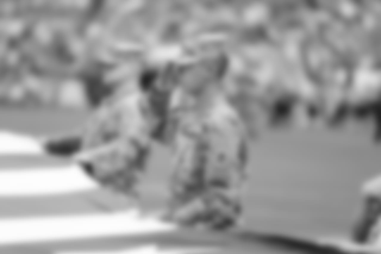 Soldiers hold the American Flag during the National Anthem.