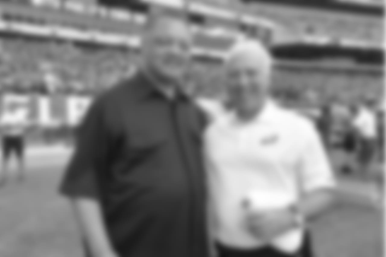 Rev. Jesse Jackson and Chairman and CEO Jeffrey Lurie take a photo on the sidelines during public practice.
