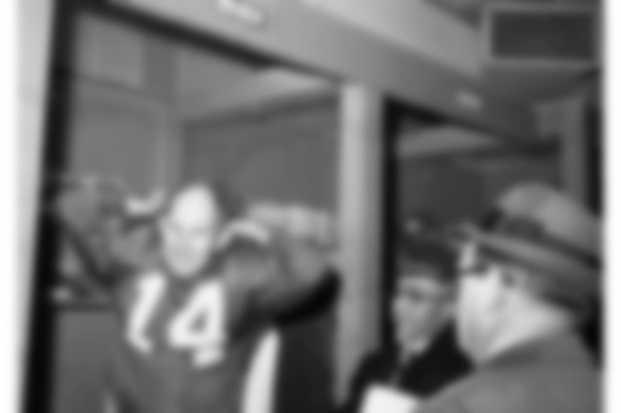 New York Giant quarterback Y.A. Tittle wears a smile as he pulls off his jersey after leading Giants to stunning 38-21 win over the Philadelphia Eagles in New York's Yankee Stadium on Nov. 12, 1961.