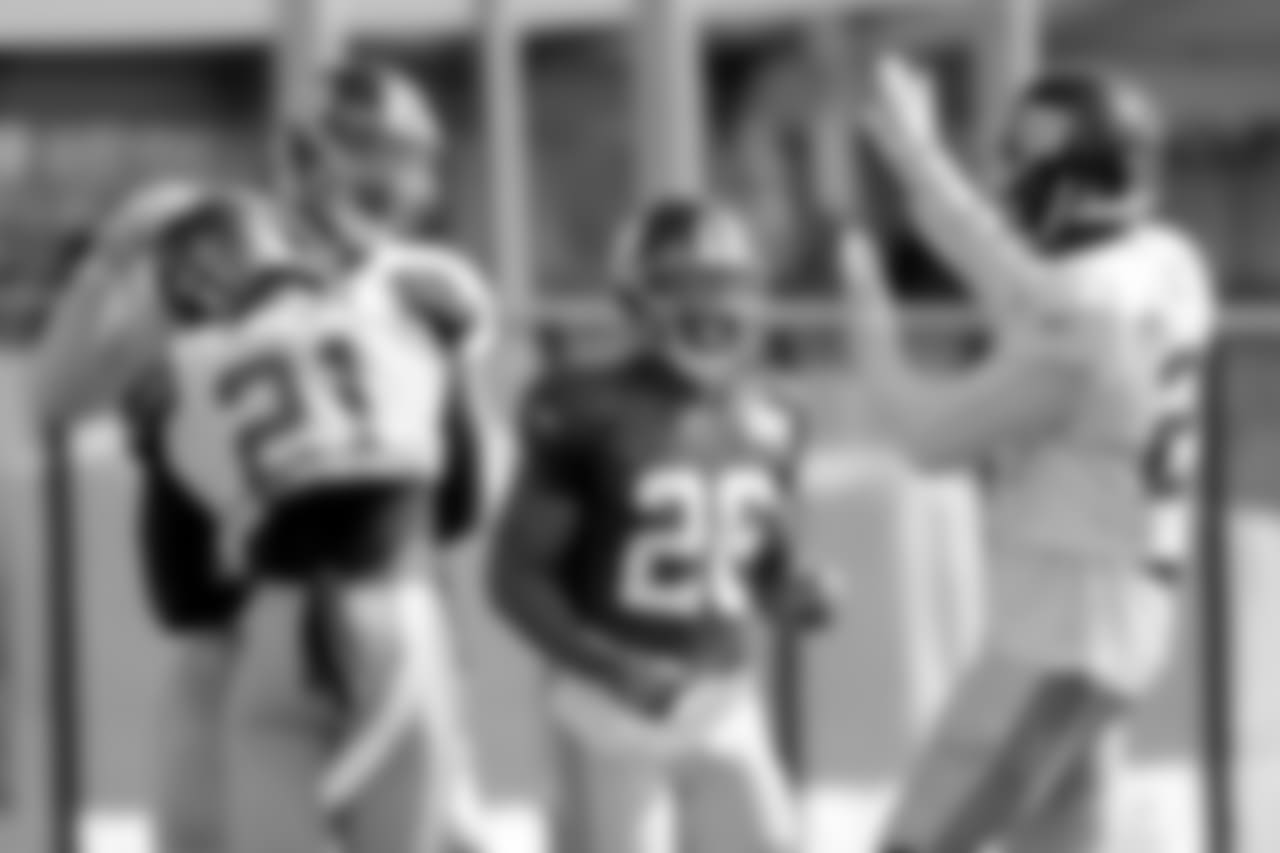 New York Giants defensive back Landon Collins (21) is congratulated by defensive end Kerry Wynn, back left, and cornerback Eli Apple, right, as running back Saquon Barkley (26) looks on after Collins intercepted a pass from quarterback Eli Manning, not pictured, during NFL football training camp, Wednesday, Aug. 1, 2018, in East Rutherford, N.J. (AP Photo/Julio Cortez)