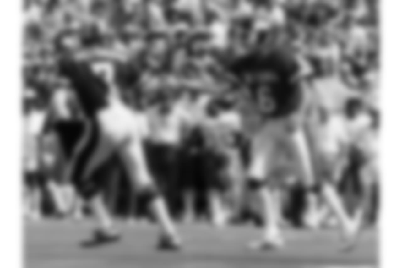 NFC quarterback Joe Theismann (7) of the Washington Redskins congratulates Giants place kicker Ali Haji-Sheikh (6) after kicking a 23-yard field goal during the NFC's 45-3 victory over the AFC in the 1984 NFL Pro Bowl played on January 29, 1984 at Aloha S