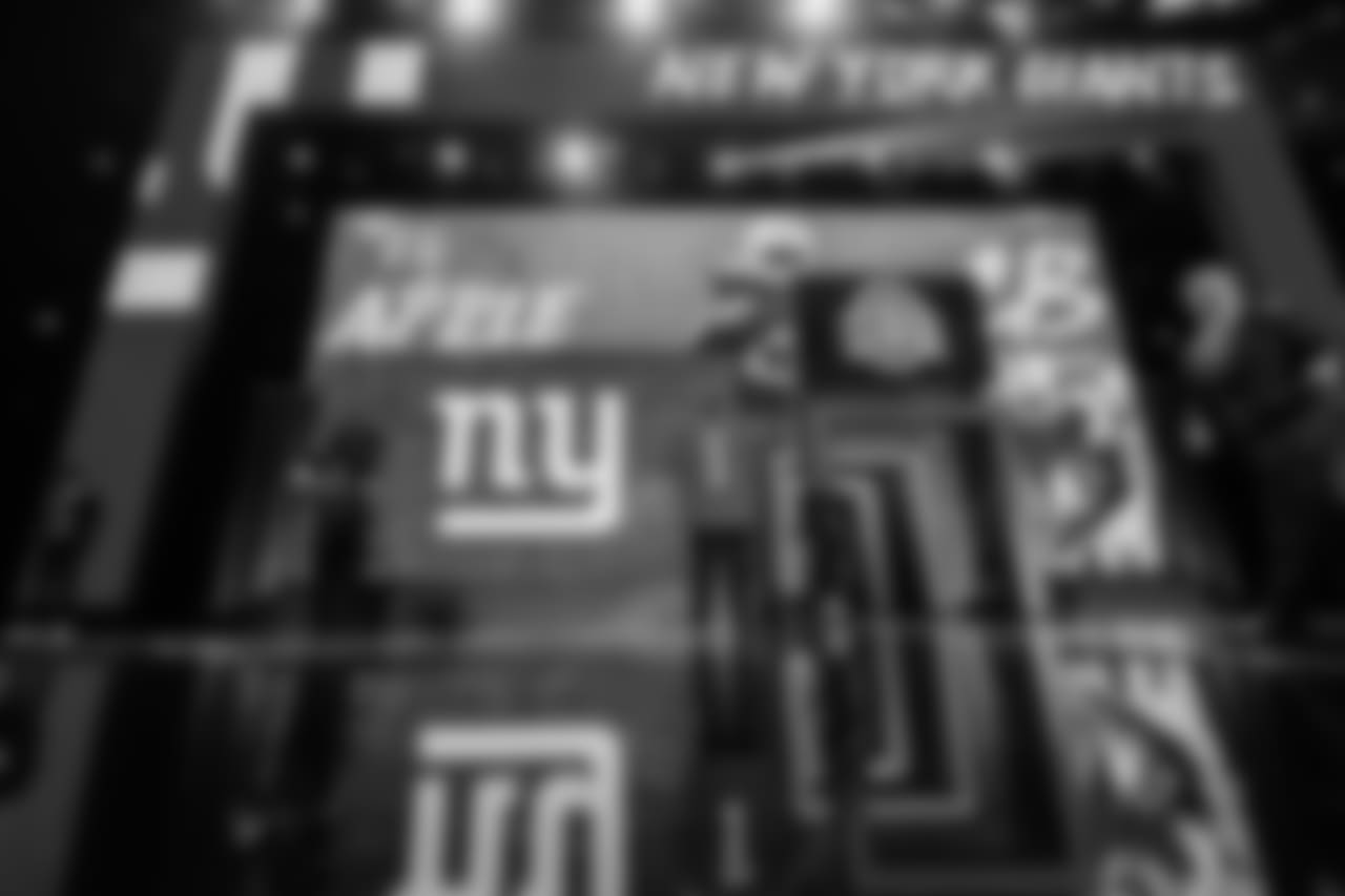 Ohio State cornerback Eli Apple holds up his jersey on stage after he is selected by the New York Giants as the tenth overall pick during the 2016 NFL Draft at the Auditorium Theatre on Thursday, April 28, 2016 in Chicago. (Ben Liebenberg via AP)