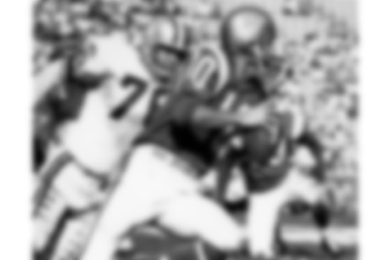 New York Giants Hall of Fame quarterback Fran Tarkenton (10) of the East rolls out to pass as Baltimore Colts defensive tackle Fred Miller (76) of the West applies pressure during the 1968 NFL Pro Bowl in Los Angeles, Calif., Jan. 21, 1968.
