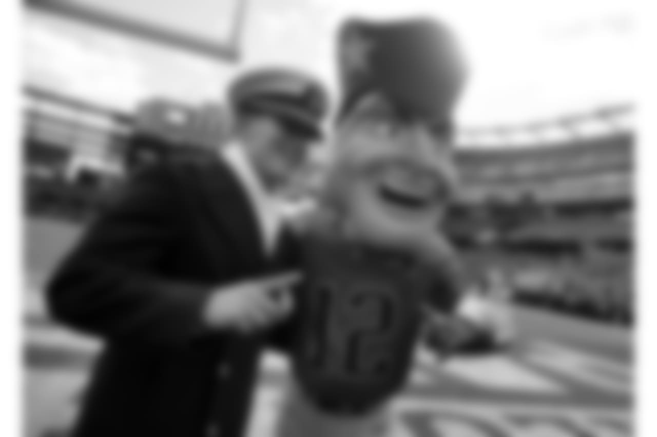 A member of the United State Navy poses with New England Patriots mascot Pat Patriot as part of the Salute to Service military appreciation campaign before an NFL football game between the Patriots and the Miami Dolphins, Sunday, Nov. 26, 2017, in Foxborough, Mass. (AP Photo/Michael Dwyer)