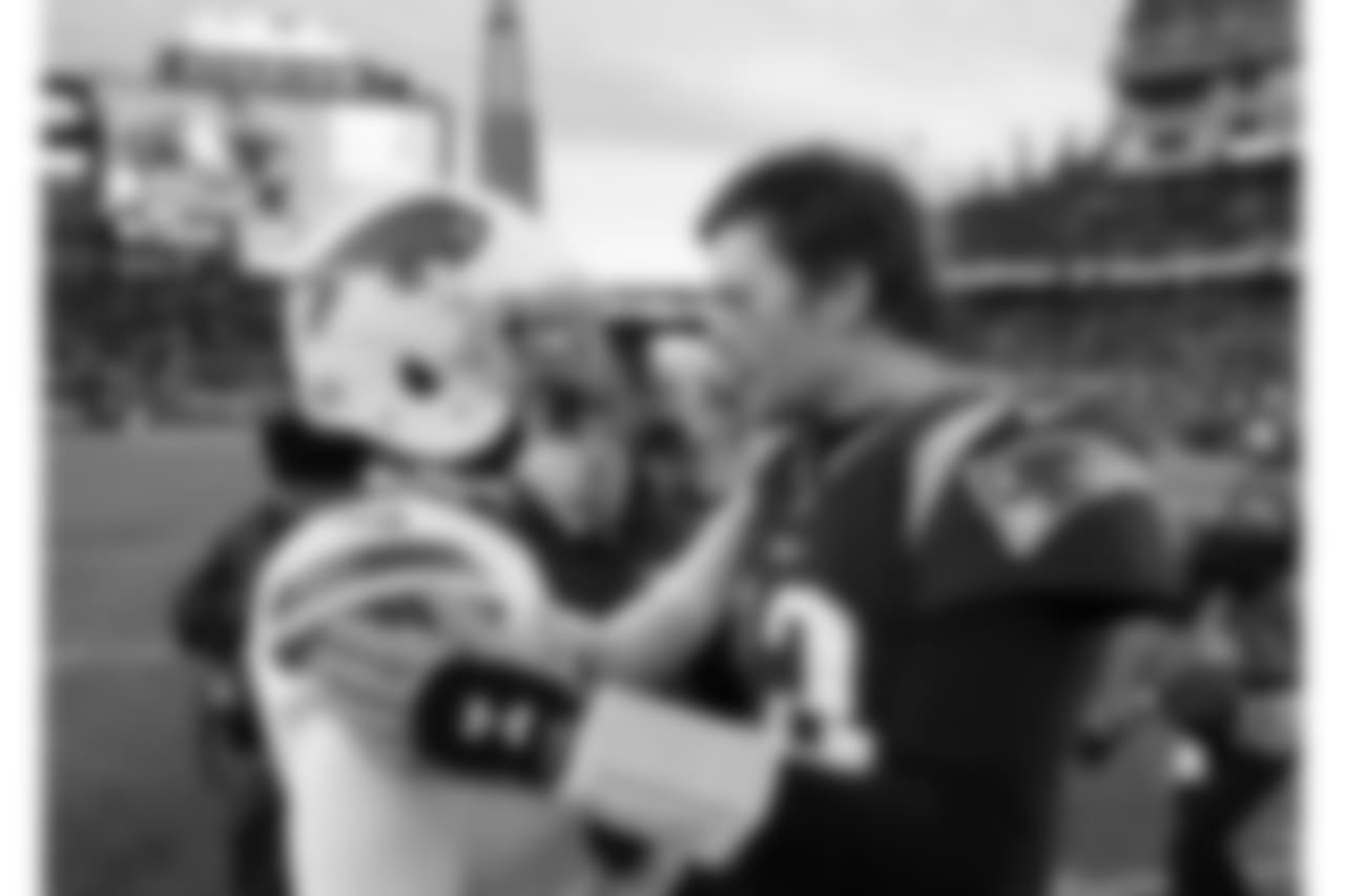 Buffalo Bills quarterback Tyrod Taylor, left, and New England Patriots quarterback Tom Brady speak at midfield after an NFL football game, Sunday, Dec. 24, 2017, in Foxborough, Mass. (AP Photo/Steven Senne)