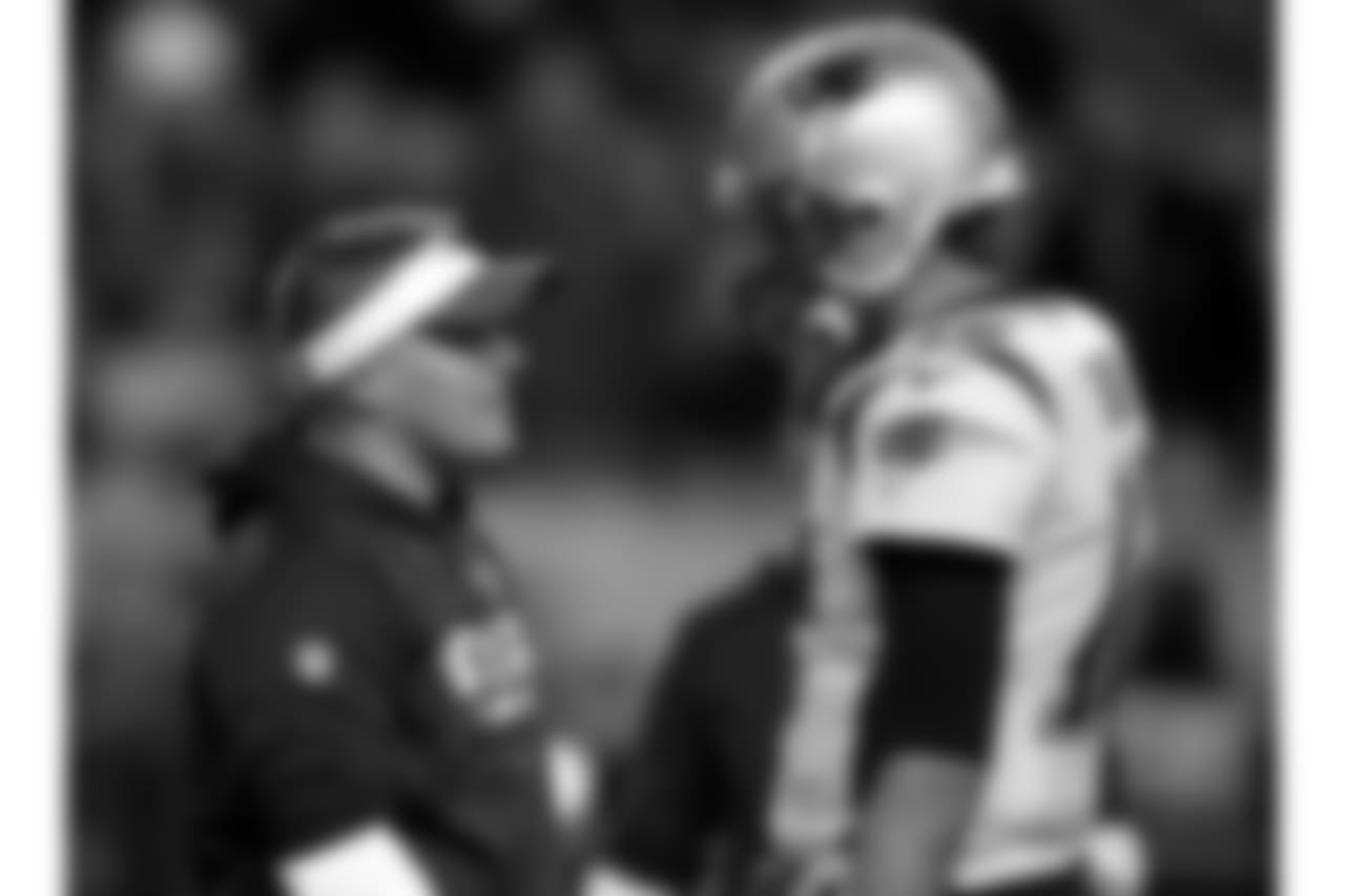 New England Patriots offensive coordinator Josh McDaniels talks with Tom Brady prior to an NFL football game against the Denver Broncos, Sunday, Nov. 12, 2017, in Denver. (AP Photo/David Zalubowski)