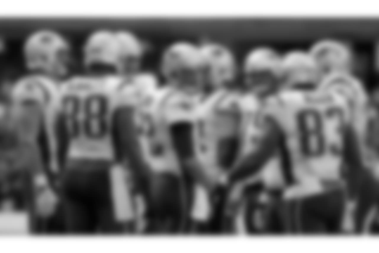 New England Patriots quarterback Tom Brady, center, huddles with his team during the first half of an NFL football game against the Oakland Raiders, Sunday, Nov. 19, 2017, in Mexico City. (AP Photo/Rebecca Blackwell)