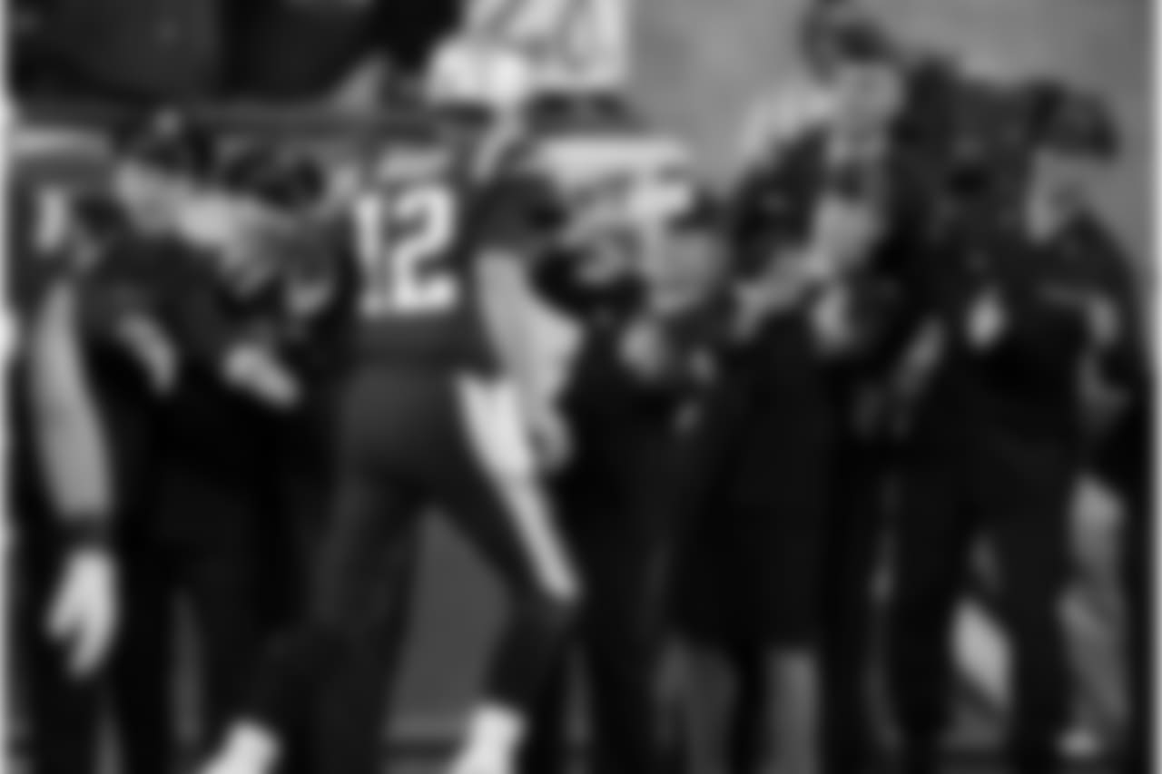 New England Patriots quarterback Tom Brady greets members of the U.S. military along the sideline before an NFL football game against the Atlanta Falcons, Sunday, Oct. 22, 2017, in Foxborough, Mass. (AP Photo/Charles Krupa)