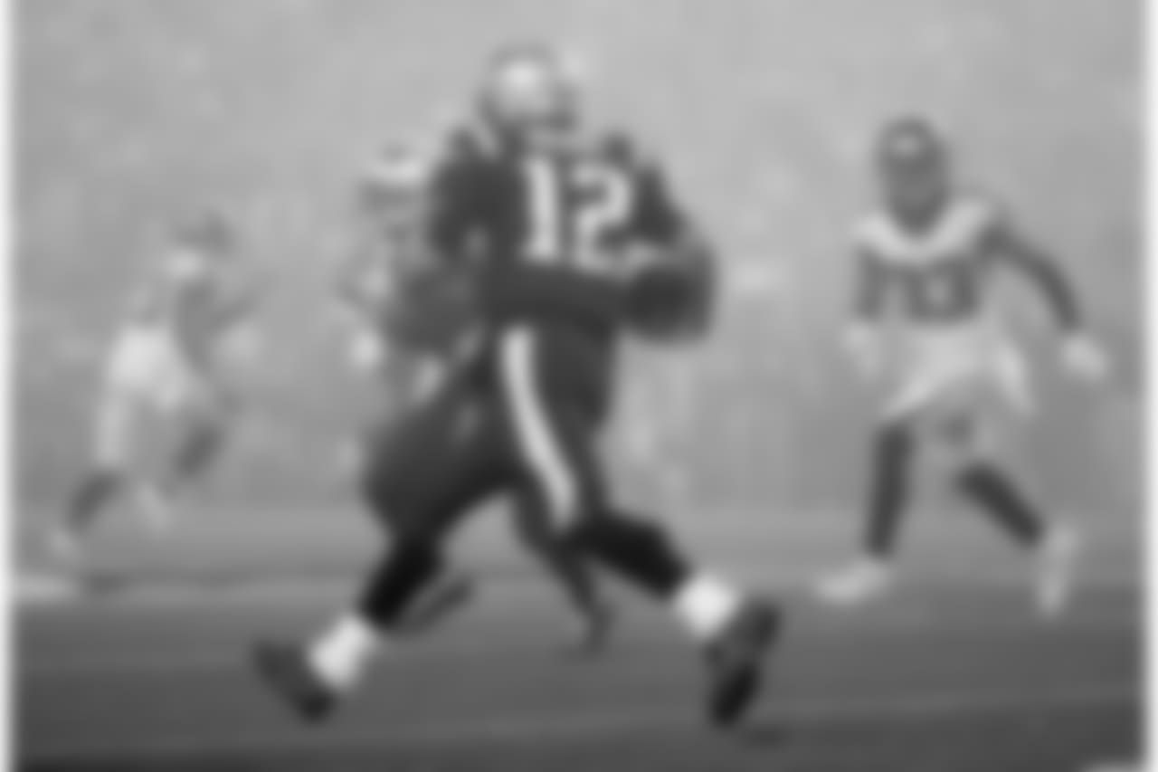 New England Patriots quarterback Tom Brady (12) runs in the fog as Atlanta Falcons defensive back Blidi Wreh-Wilson (33) pursues during the second half of an NFL football game, Sunday, Oct. 22, 2017, in Foxborough, Mass. (AP Photo/Steven Senne)