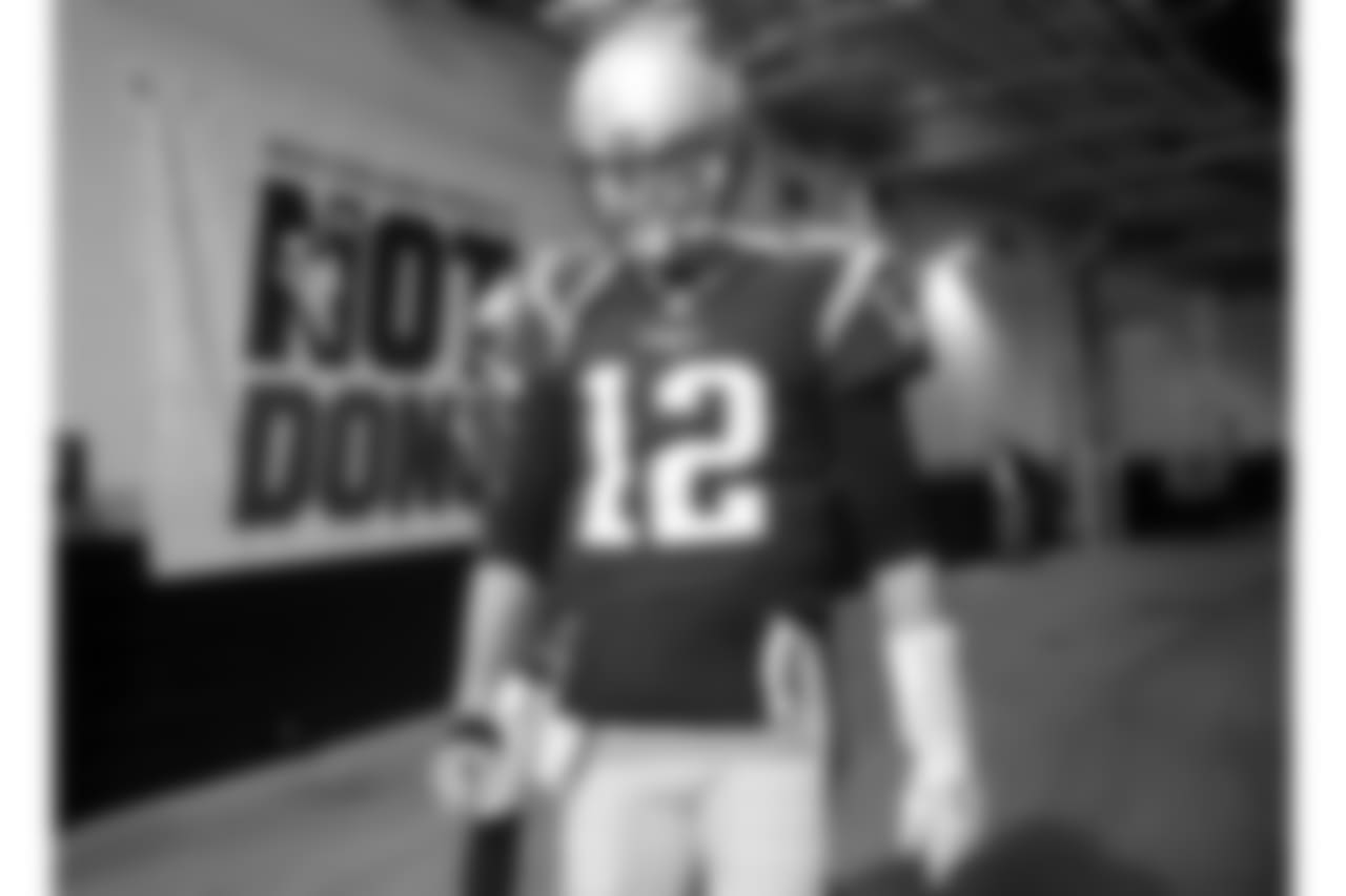 New England Patriots quarterback Tom Brady walks toward the field to warm up before the AFC championship NFL football game against the Jacksonville Jaguars, Sunday, Jan. 21, 2018, in Foxborough, Mass. (AP Photo/Winslow Townson)