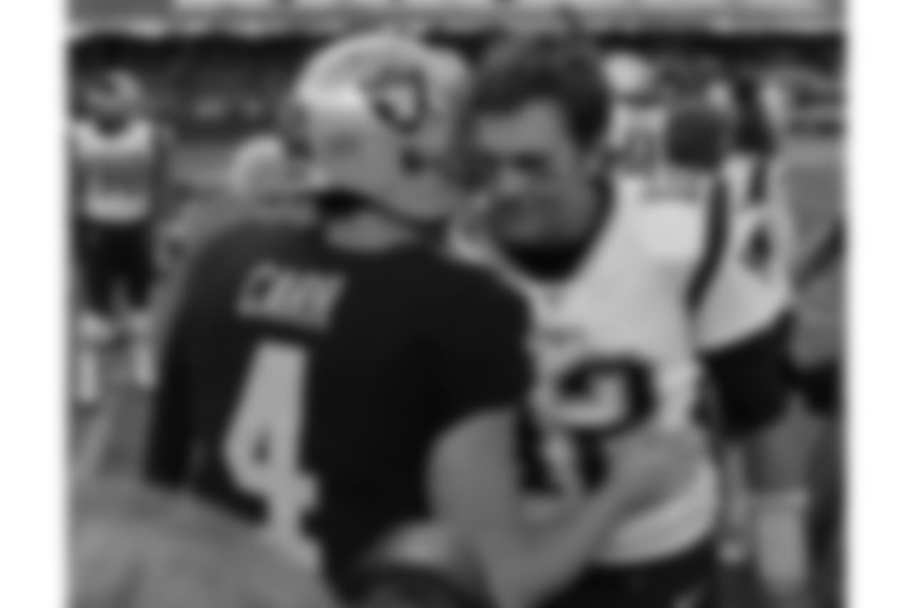 New England Patriots quarterback Tom Brady, right, talks with Oakland Raiders quarterback Derek Carr (4) after an NFL football game Sunday, Nov. 19, 2017, in Mexico City. (AP Photo/Eduardo Verdugo)