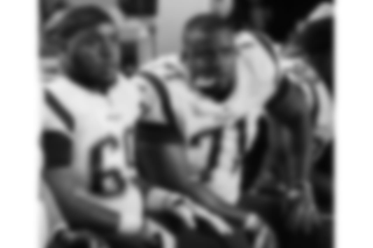 New England Patriots offensive guard Shaq Mason (69) and offensive tackle Cameron Fleming (71) watch the game from the sidelines, during the first half of an NFL football game against the Miami Dolphins, Monday, Dec. 11, 2017, in Miami Gardens, Fla. (AP Photo/Lynne Sladky)