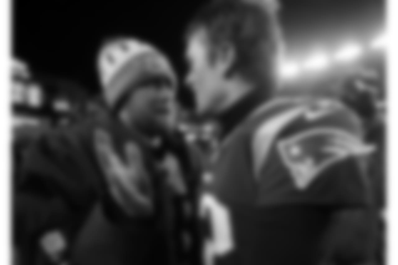 Former teammates Tennessee Titans backup quarterback Matt Cassel, left, and New England Patriots quarterback Tom Brady speak at midfield after an NFL divisional playoff football game, Saturday, Jan. 13, 2018, in Foxborough, Mass. (AP Photo/Michael Dwyer)