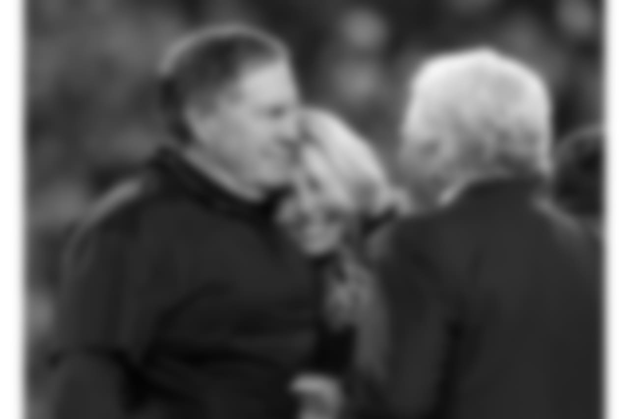 New England Patriots head coach Bill Belichick, hugs his girlfriend Linda Holliday as he talks to team owner Robert Kraft after winning the AFC championship NFL football game against the Jacksonville Jaguars, Sunday, Jan. 21, 2018, in Foxborough, Mass. The Patriots won 24-20. (AP Photo/Winslow Townson)
