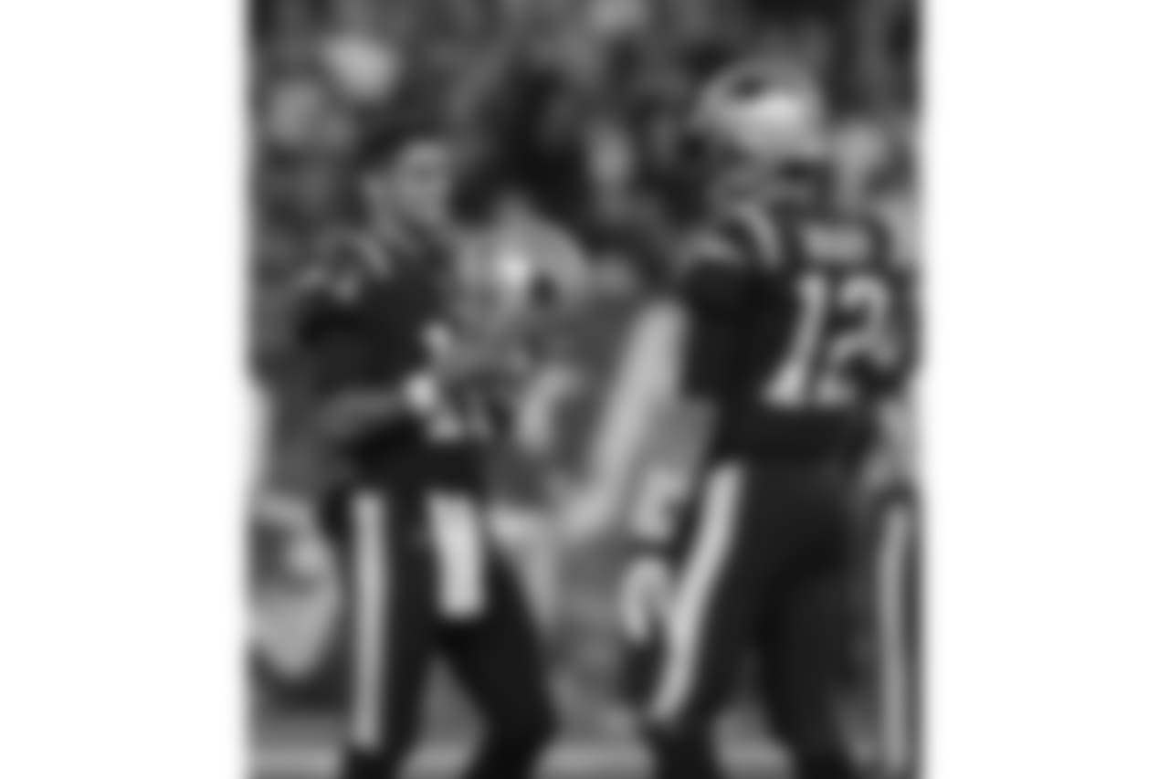 New England Patriots quarterbacks Jimmy Garoppolo, left, and Tom Brady speak while warming up before an NFL football game against the Atlanta Falcons, Sunday, Oct. 22, 2017, in Foxborough, Mass. (AP Photo/Charles Krupa)