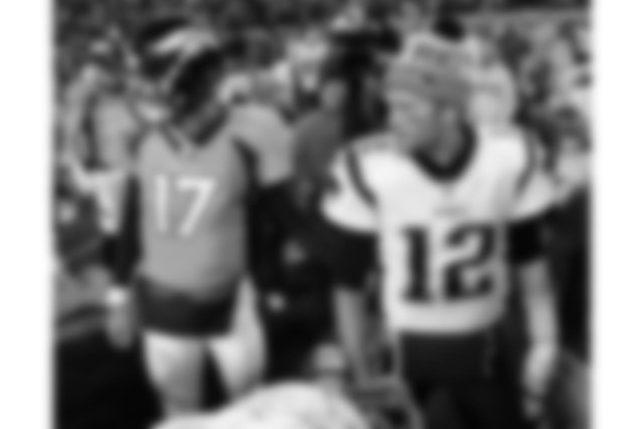 New England Patriots quarterback Tom Brady (12) and Denver Broncos quarterback Brock Osweiler (17) meet after an NFL football game, Sunday, Nov. 12, 2017, in Denver. The Patriots won 41-16. (AP Photo/Jack Dempsey)