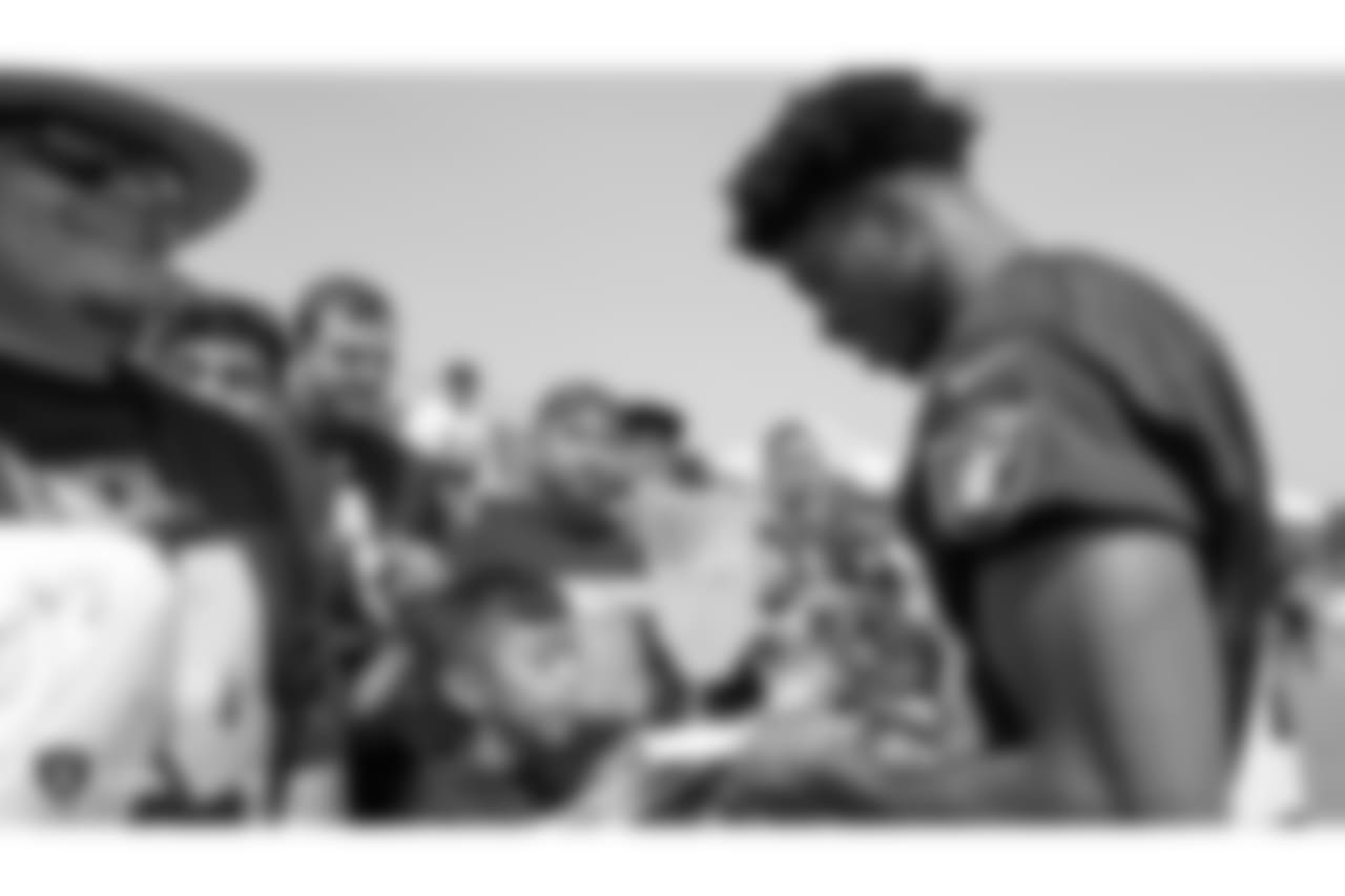 Oakland Raiders safety Obi Melifonwu (20) signs autographs for fans after practice at 2018 Training Camp at The Oakland Raiders Napa Valley Training Complex, Wednesday, August 1, 2018, in Napa, California.