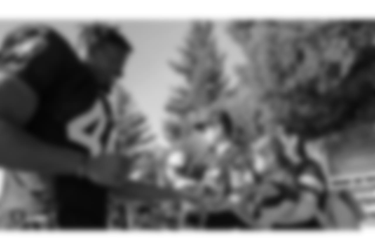 Oakland Raiders linebacker Jason Cabinda (46) signs autographs for fans after practice at 2018 Training Camp at The Oakland Raiders Napa Valley Training Complex, Monday, July 30, 2018, in Napa, California.