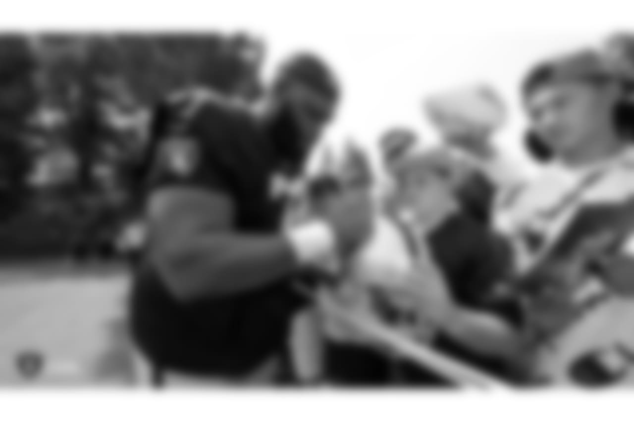 Oakland Raiders defensive tackle Justin Ellis (78) signs autographs for fans after practice at 2018 Training Camp at The Oakland Raiders Napa Valley Training Complex, Sunday, July 29, 2018, in Napa, California.