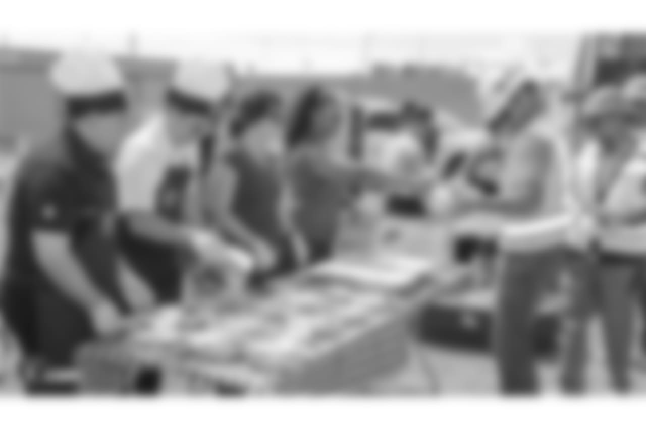 Staff members from The Oakland Raiders front office spend the day with construction workers of the Las Vegas Stadium worksite by handing out lunches and sharing a meal, Wednesday, June 28, 2018, at the Las Vegas Stadium worksite in Las Vegas, Nevada.