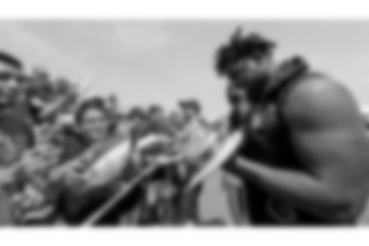 Oakland Raiders defensive end Mario Edwards Jr. (97) signs autographs for fans after practice at 2018 Training Camp at The Oakland Raiders Napa Valley Training Complex, Sunday, July 29, 2018, in Napa, California.