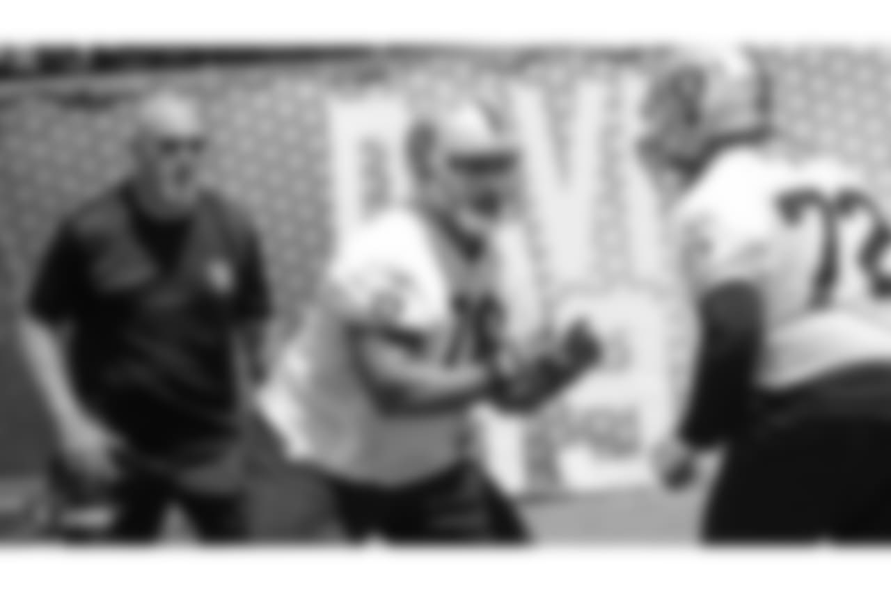 Oakland Raiders offensive line coach Tom Cable, offensive guard Jon Feliciano (76), and offensive tackle Donald Penn (72) at an Organized Team Activity (OTA) at the Oakland Raiders Practice Facility, Tuesday, June 5, 2018, in Alameda, California.