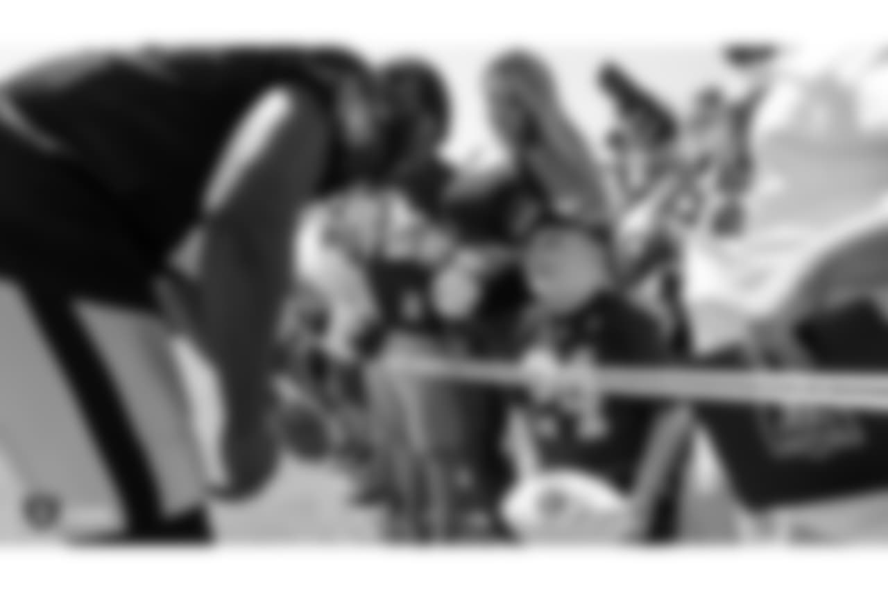 Oakland Raiders linebacker Azeem Victor (57) signs autographs for fans after practice at 2018 Training Camp at The Oakland Raiders Napa Valley Training Complex, Monday, August 6, 2018, in Napa, California.