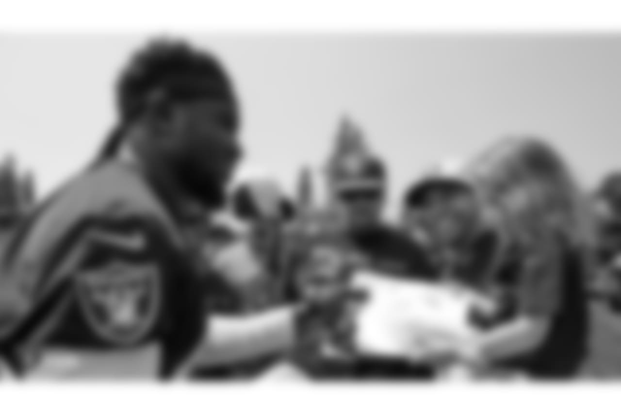 Oakland Raiders strong safety Karl Joseph (42) signs autographs for fans after practice at 2018 Training Camp at The Oakland Raiders Napa Valley Training Complex, Wednesday, August 1, 2018, in Napa, California.