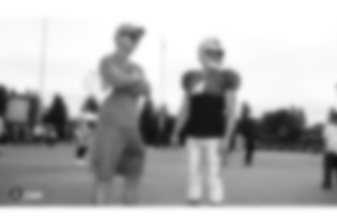 Former NFL quarterback Peyton Manning and quarterback Derek Carr (4) on the field for practice at 2018 Training Camp at The Oakland Raiders Napa Valley Training Complex, Thursday, August 2, 2018, in Napa, California.