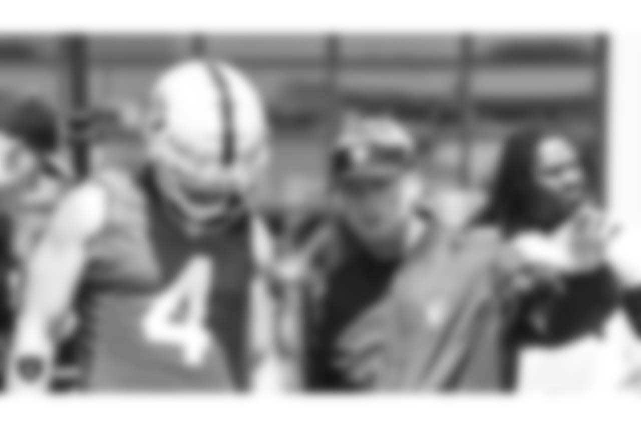 Oakland Raiders quarterback Derek Carr (4) and head coach Jon Gruden at an Organized Team Activity (OTA) at the Oakland Raiders Practice Facility, Thursday, May 31, 2018, in Alameda, California.