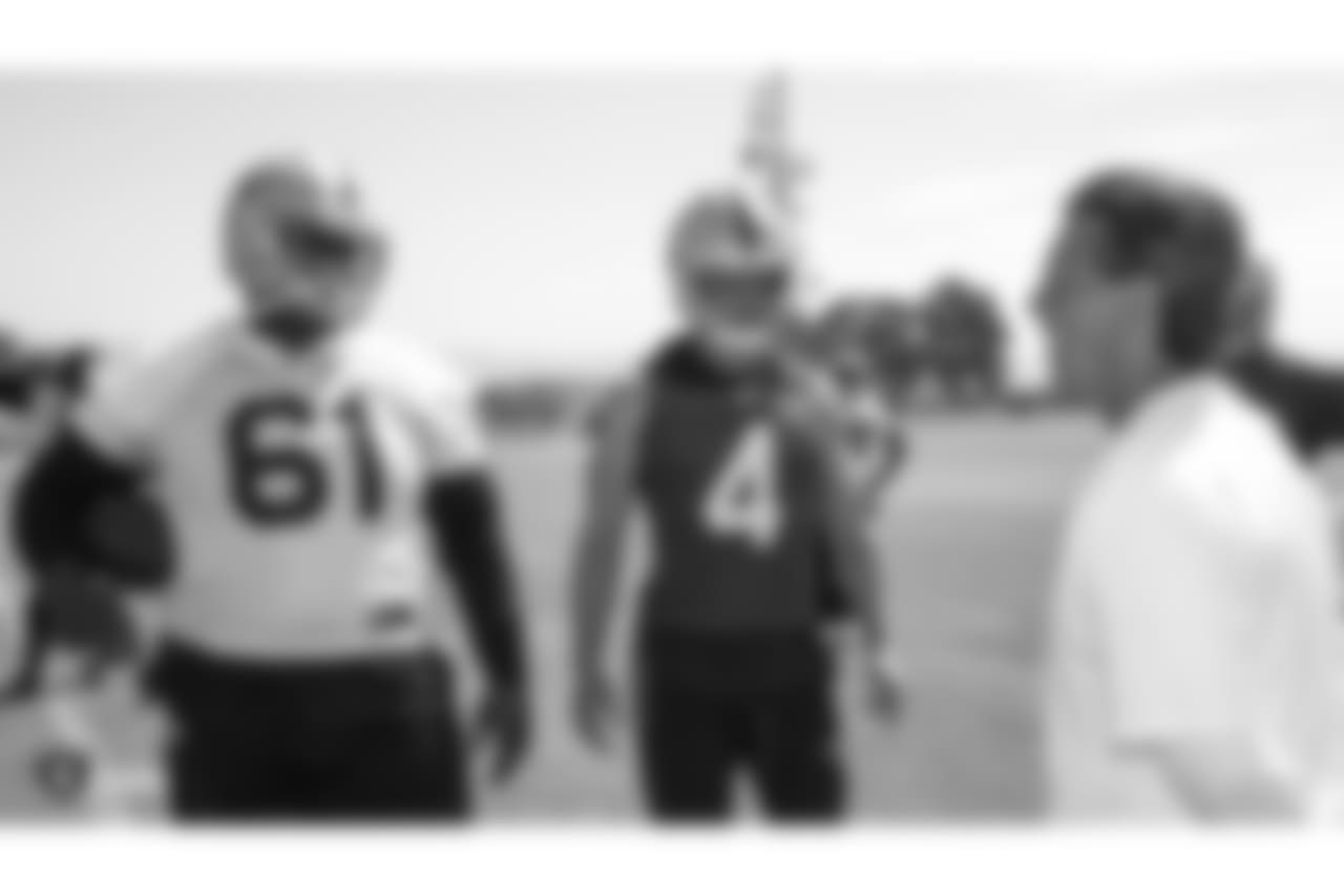 Oakland Raiders center Rodney Hudson (61), quarterback Derek Carr (4), and offensive coordinator Greg Olson at an Organized Team Activity (OTA) at the Oakland Raiders Practice Facility, Tuesday, June 5, 2018, in Alameda, California.