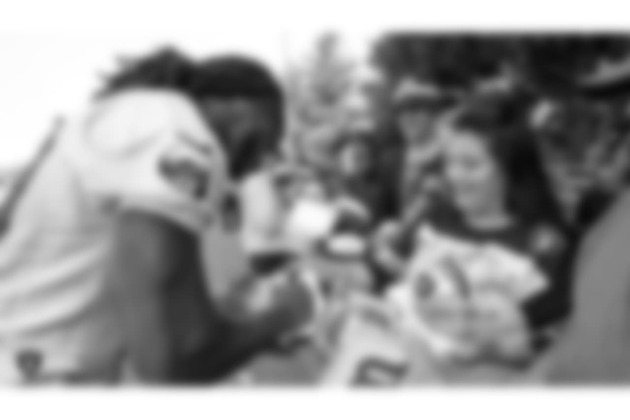 Oakland Raiders wide receiver Isaac Whitney (19) signs autographs for fans after practice at 2018 Training Camp at The Oakland Raiders Napa Valley Training Complex, Thursday, August 2, 2018, in Napa, California.