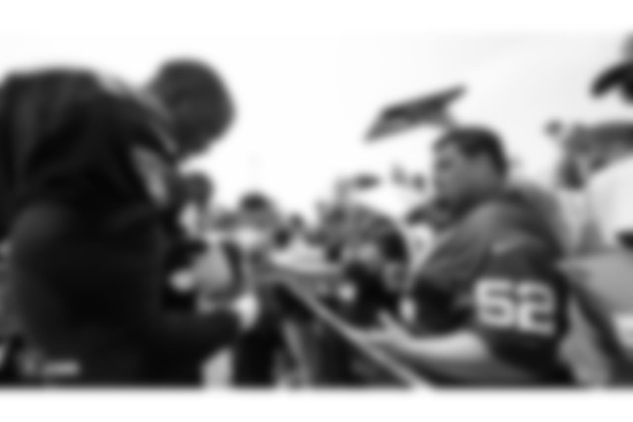 Oakland Raiders defensive lineman Tank Carradine (96) signs autographs for fans after practice at 2018 Training Camp at The Oakland Raiders Napa Valley Training Complex, Sunday, July 29, 2018, in Napa, California.