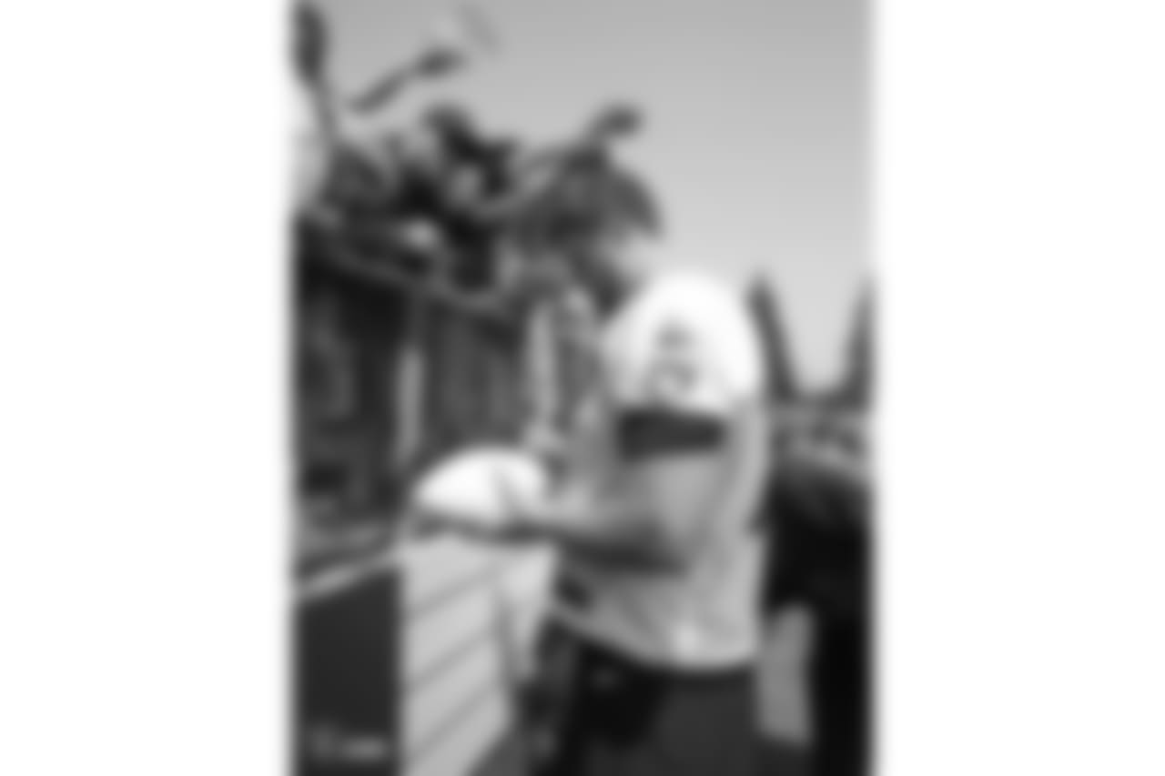 Oakland Raiders offensive tackle Kolton Miller (77) signs autographs for fans after practice at 2018 Training Camp at Memorial Stadium, Saturday, July 28, 2018, in Napa, California.