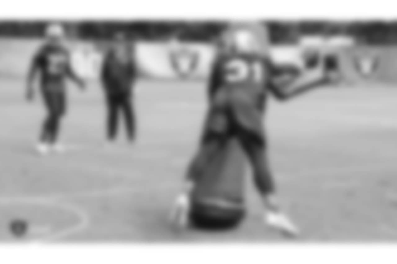 Oakland Raiders free safety Reggie Nelson (27), head coach Jon Gruden, and safety Marcus Gilchrist (31) at an Organized Team Activity (OTA) at the Oakland Raiders Practice Facility, Wednesday, May 30, 2018, in Alameda, California.