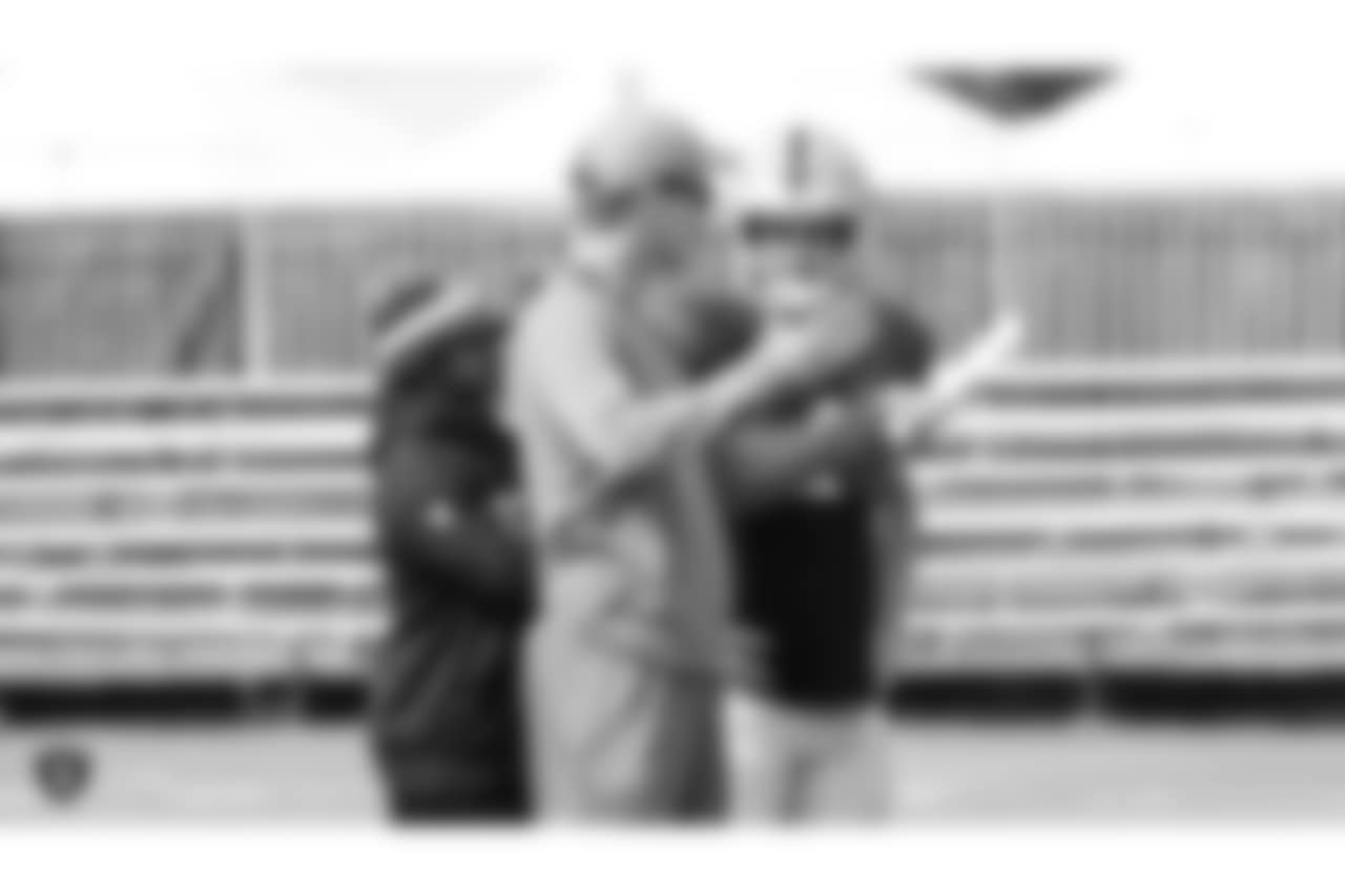 Former NFL quarterback Peyton Manning and Oakland Raiders quarterback Derek Carr (4) on the field for practice at 2018 Training Camp at The Oakland Raiders Napa Valley Training Complex, Thursday, August 2, 2018, in Napa, California.