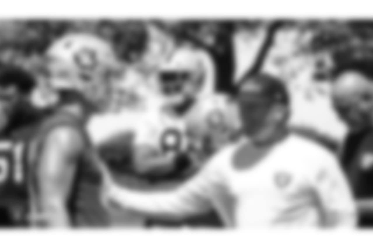 Oakland Raiders quarterback Derek Carr (4) and head coach Jon Gruden at a Mandatory Minicamp at the Oakland Raiders Practice Facility, Wednesday, June 13, 2018, in Alameda, California.