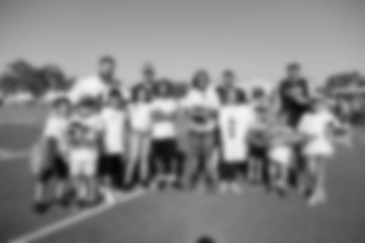 Los Angeles Rams players Punter (06) Johnny Hekker, Long Snapper (44) Jake McQuaide, Kicker (04) Greg Zuerlein, and Kicker (05) Sam Ficken pose with Helpful Honda Rookie fans for a group photo during Day 1 of Training Camp, Thursday, July 26, 2018, in Irvine, CA. (Will Navarro/Rams)