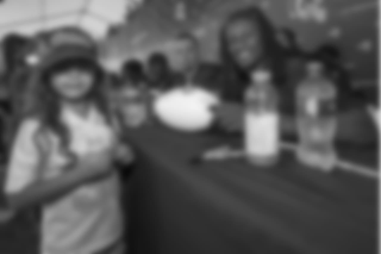 A young fan and Running back #30 Todd Gurley of the Los Angeles Rams during autograph signing for the 2018-2019 season Day one of training camp, at UC Irvine, in Irvine Calif., on July 26th, 2018. (Daniel Bowyer/Rams)