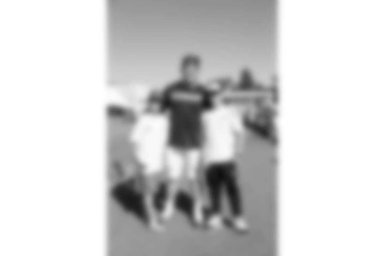 Defensive tackle (61) McKay Murphy of the Los Angeles Rams takes a photo with fans during Day 5 of Training Camp, Monday, July 30, 2018, in Irvine, CA. (Will Navarro/Rams)