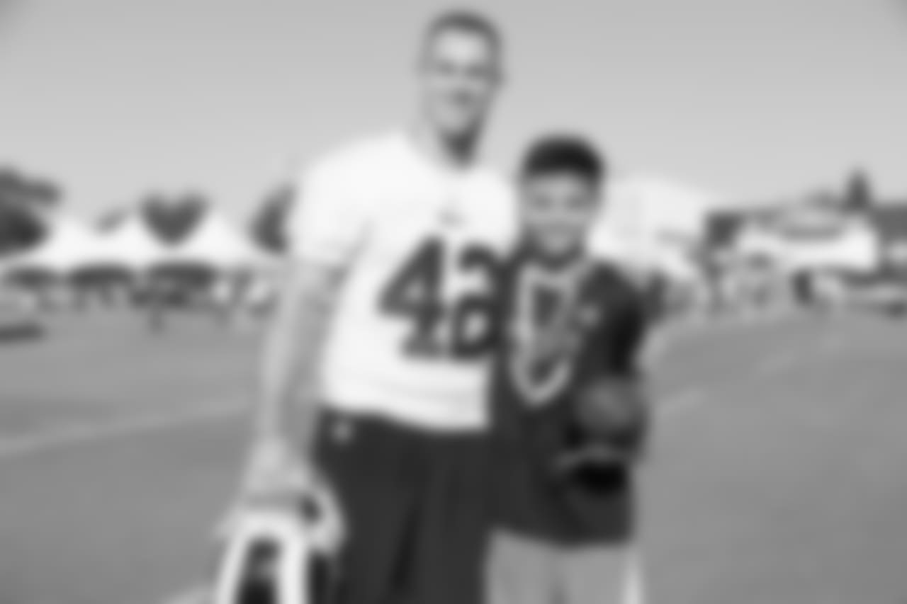Safety (42) Nate Holley of the Los Angeles Rams poses for a photo with a fan during Day 3 of Training Camp, Saturday, July 28, 2018, in Irvine, CA. (Will Navarro/Rams)