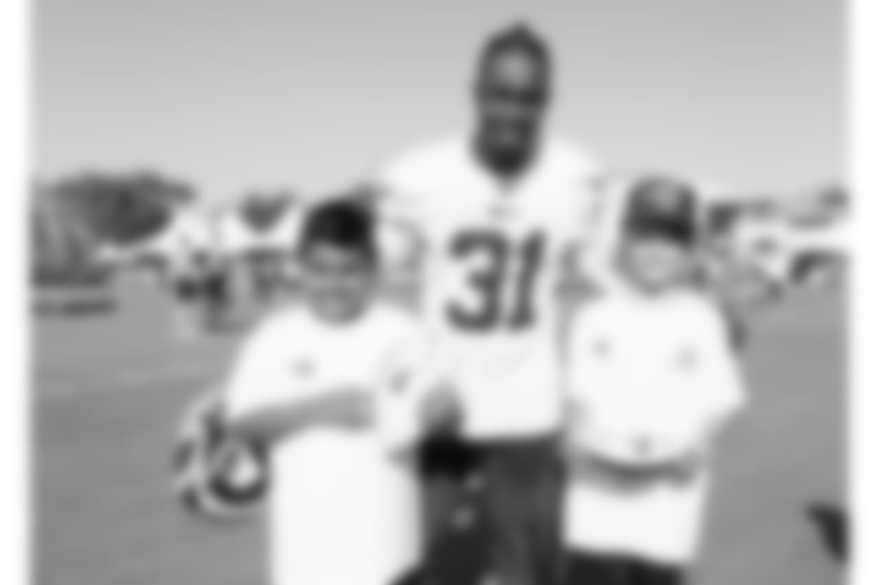 Cornerback (31) Taurean Nixon of the Los Angeles Rams poses for a photo with a fan during Day 3 of Training Camp, Saturday, July 28, 2018, in Irvine, CA. (Will Navarro/Rams)