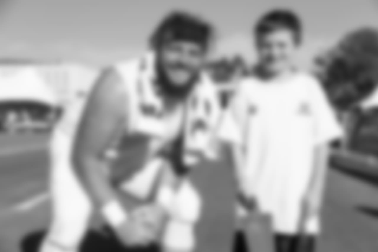 Center (72) Aaron Neary of the Los Angeles Rams takes a photo with fans during Day 6 of Training Camp, Wednesday, August 01, 2018, in Irvine, CA. (Will Navarro/Rams)