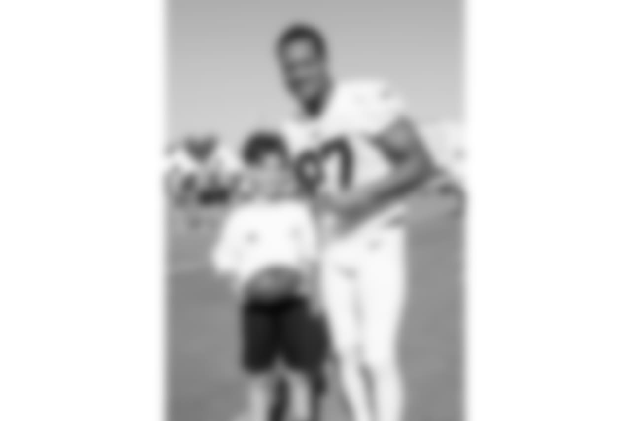 Defensive back (27) Isaiah Johnson of the Los Angeles Rams poses for a photo with a fan during Day 3 of Training Camp, Saturday, July 28, 2018, in Irvine, CA. (Will Navarro/Rams)