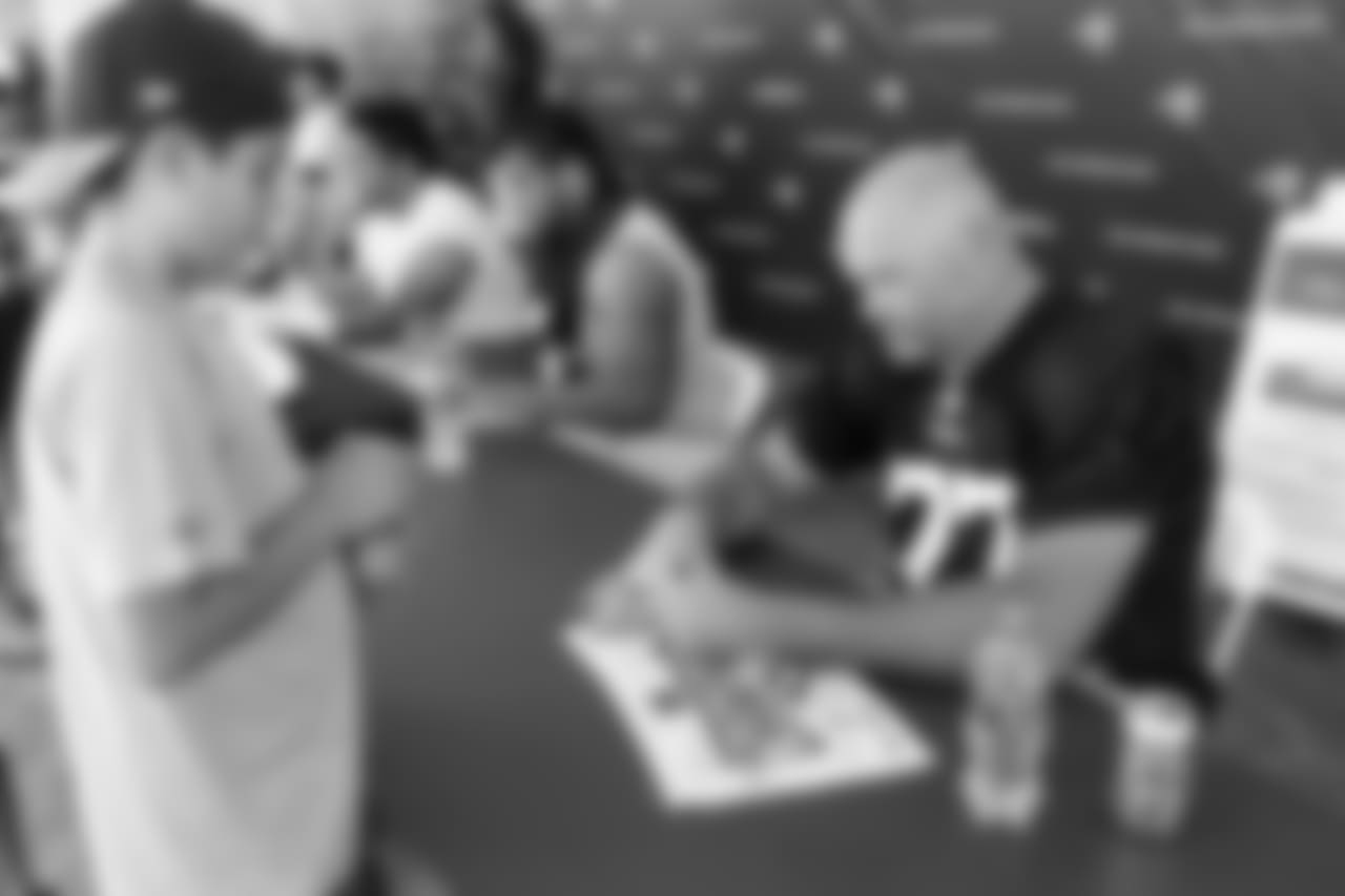 Offensive tackle (77) Andrew Whitworth of the Los Angeles Rams signs autographs during Day 6 of Training Camp, Wednesday, August 01, 2018, in Irvine, CA. (Will Navarro/Rams)